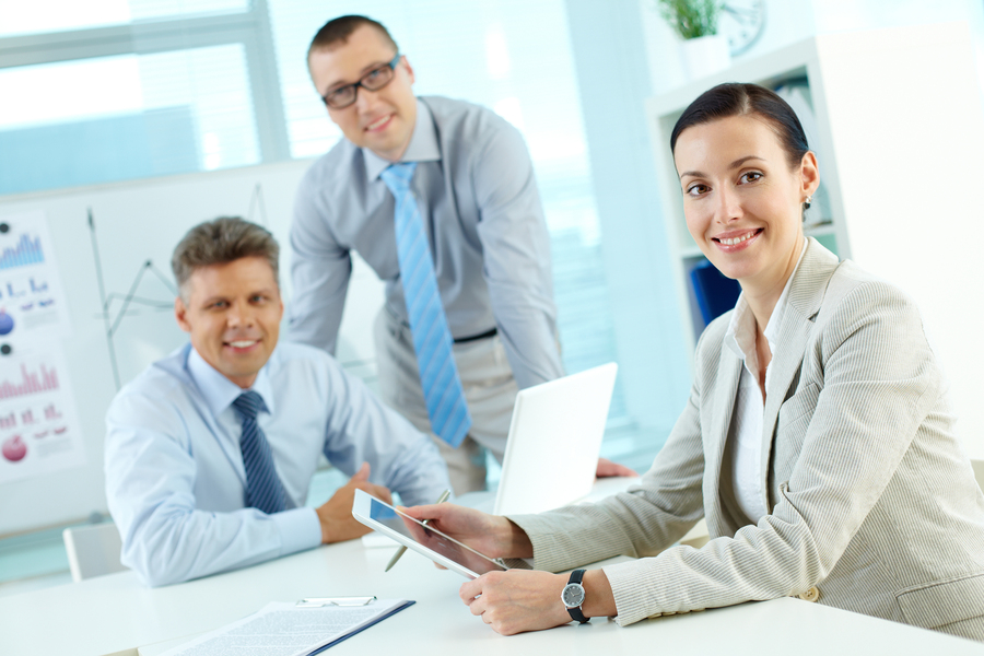 Portrait of pretty lady looking at camera in working environment in office